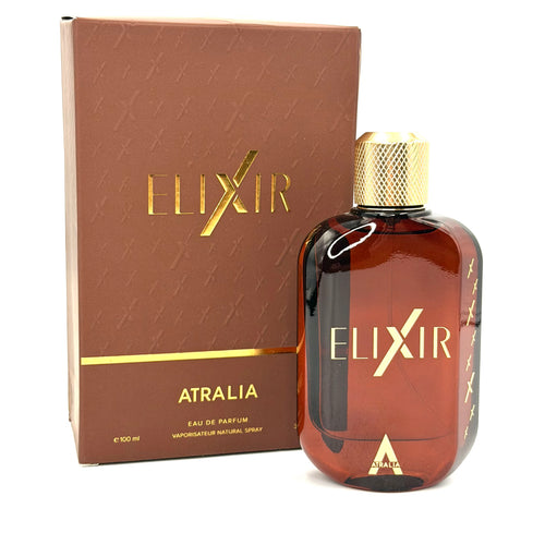 A bottle of Elixir Atralia Eau de Parfum next to its brown packaging box with gold lettering, on a white background.
