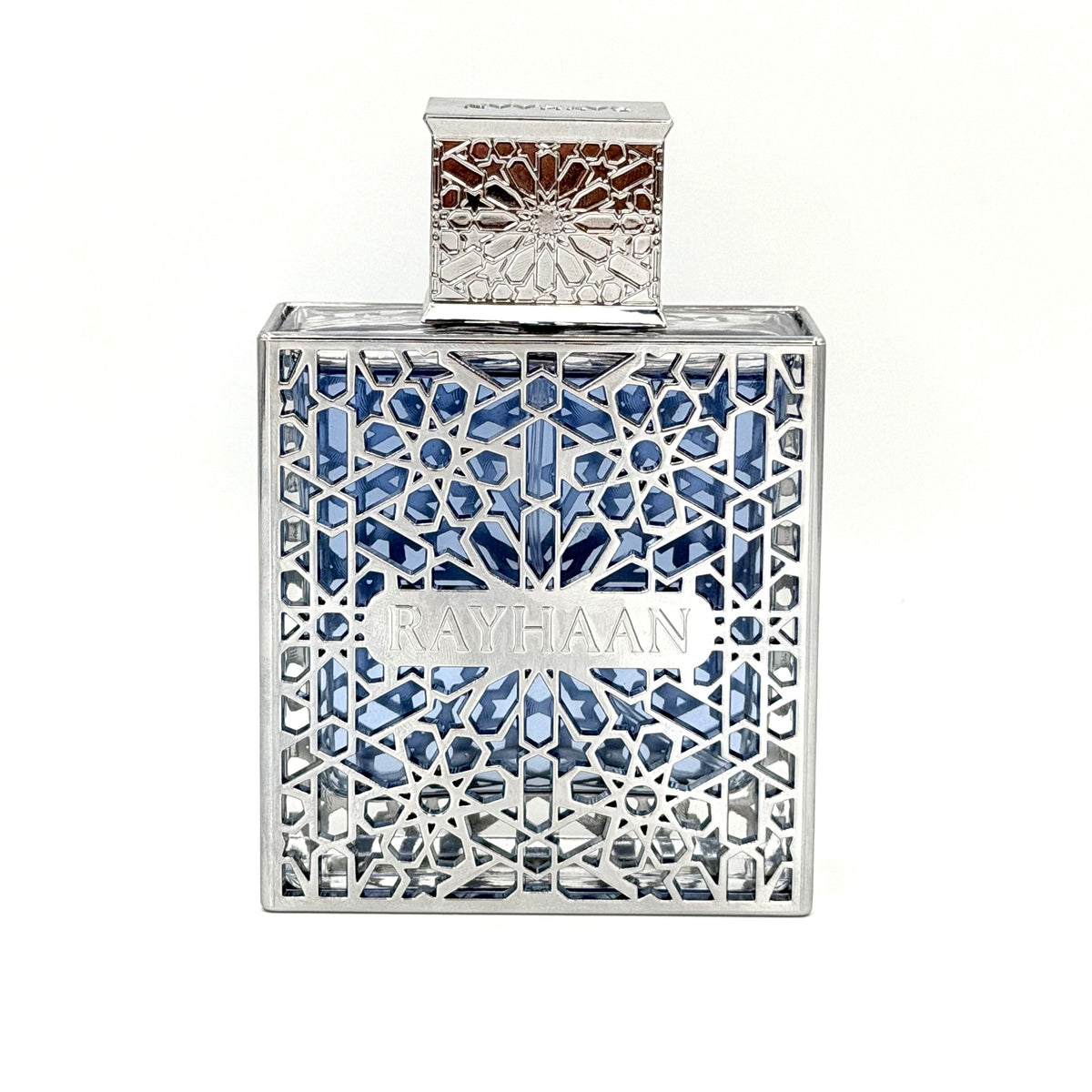 A square-shaped Rayhaan perfume bottle with a silver-toned geometric filigree frame and blue faceted crystals inside, set against a plain white background.